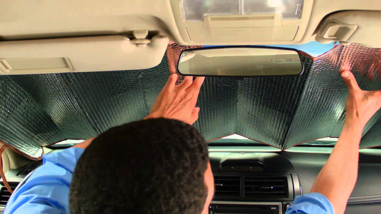 Man setting up car sun shades