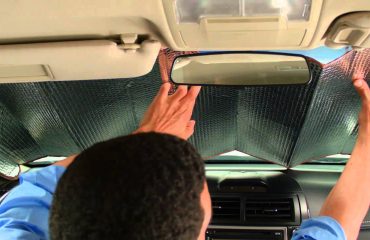 Man setting up car sun shades